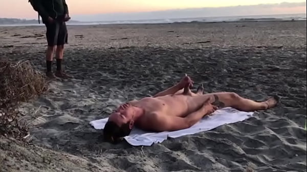 cumming on the beach with an admirer